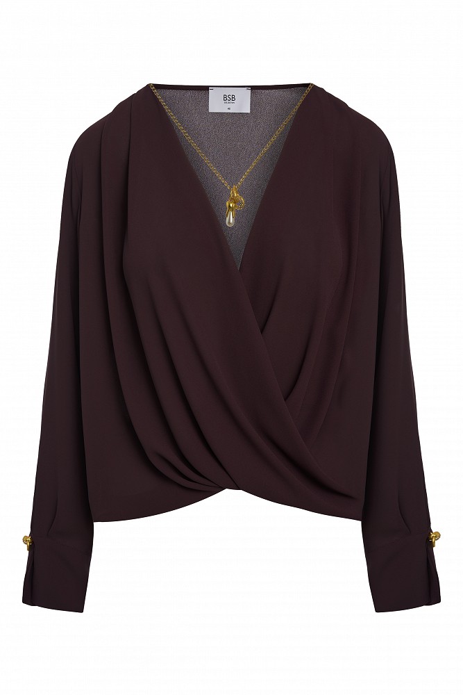 Wrap blouse with a decorative necklace