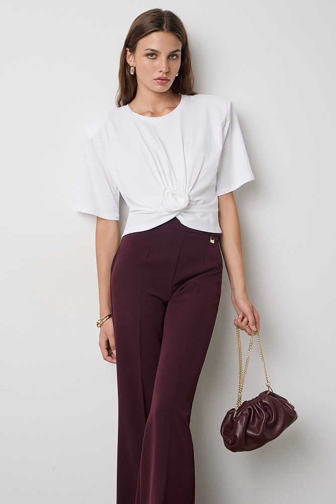 Cropped top with shoulder pads and appliqué flower