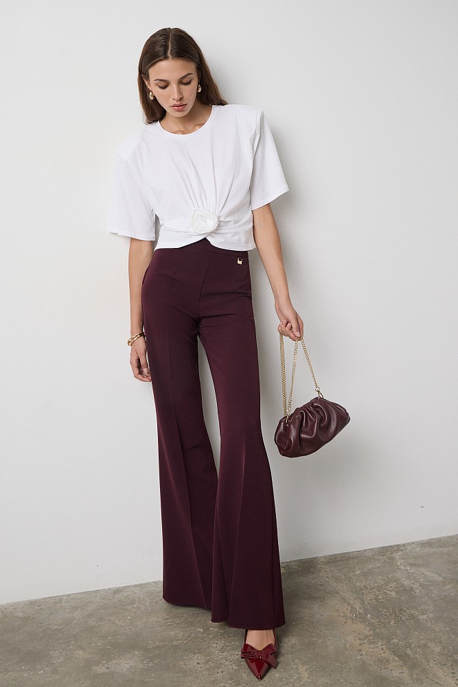 Cropped top with shoulder pads and appliqué flower