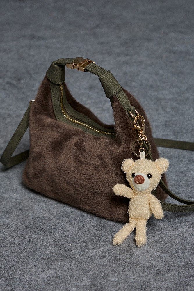 Furry bag with hanging accessory