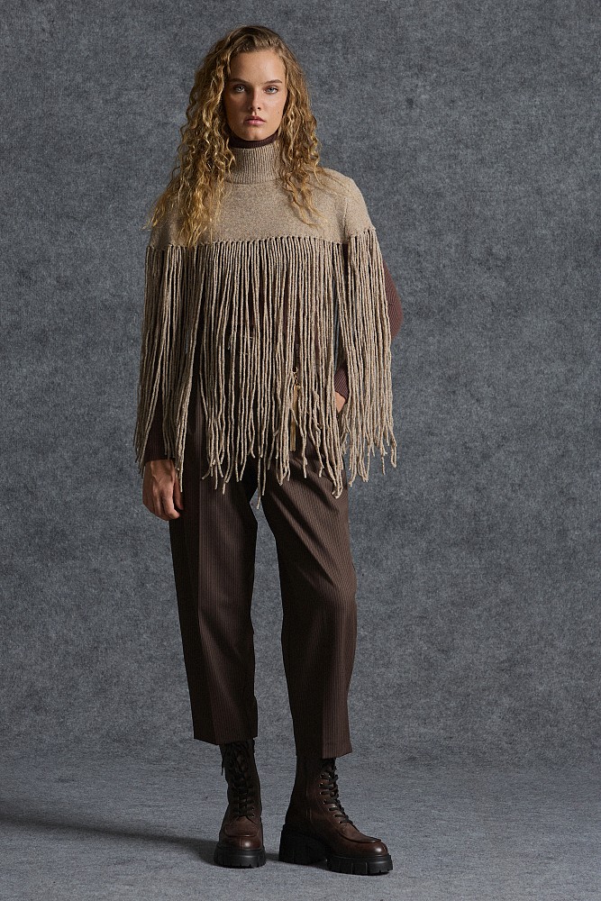 Knitted fringed cape