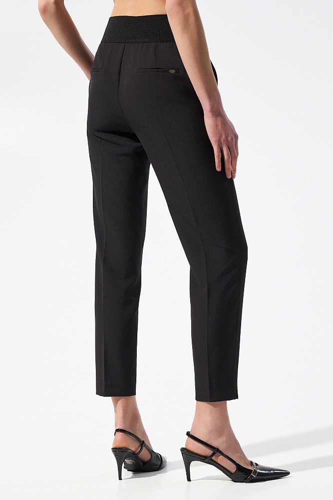 Trousers with bejeweled buttons