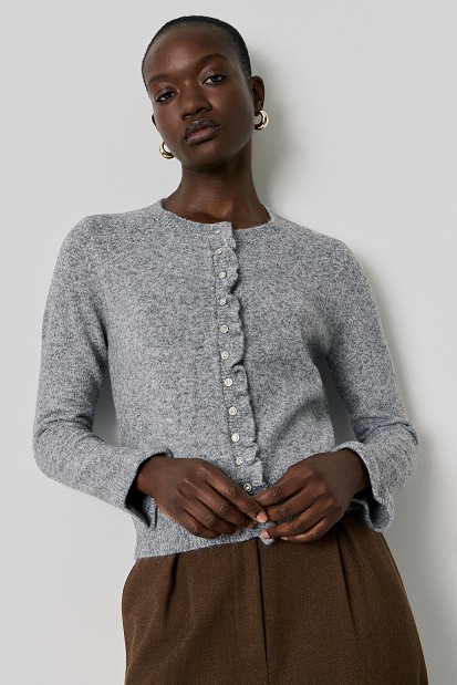 Knitted cardigan with jewel buttons and ruffles