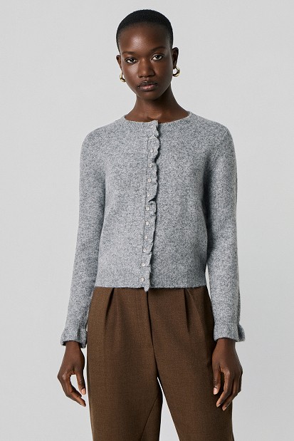 Knitted cardigan with jewel buttons and ruffles