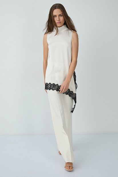 Sleeveless satin turtleneck top with asymmetrical lace hem