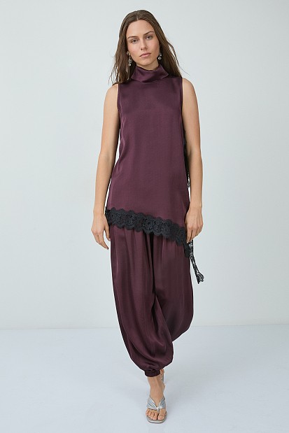 Sleeveless satin turtleneck top with asymmetrical lace hem