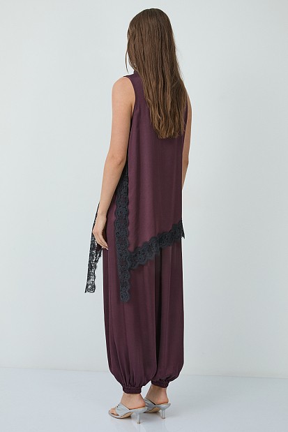 Sleeveless satin turtleneck top with asymmetrical lace hem