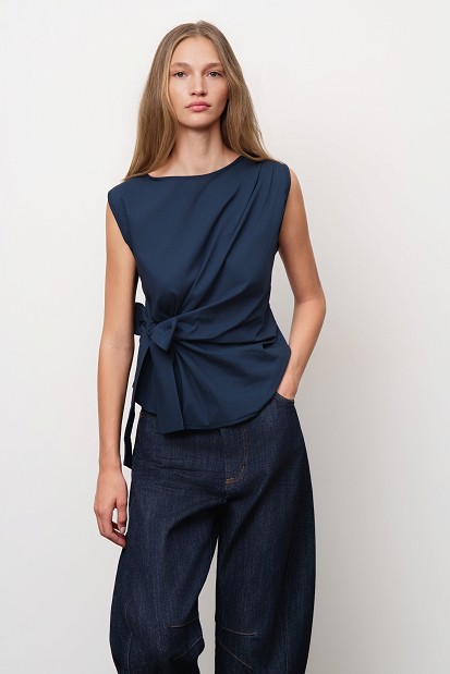 Sleeveless top with a decorative bow