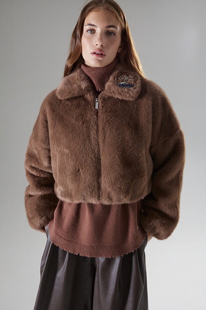 Cropped bomber jacket with decorative pins on the collar