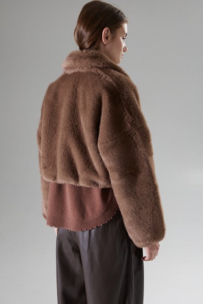 Cropped bomber jacket with decorative pins on the collar