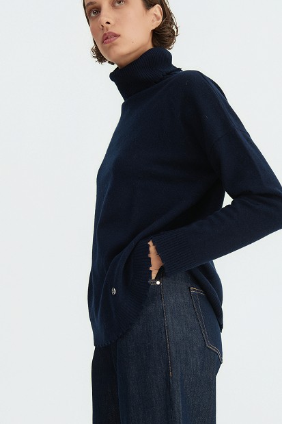 Wool turtleneck sweater with distressed details