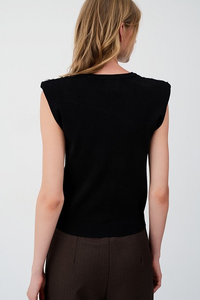 Sleeveless sweater with rhinestone embellishments