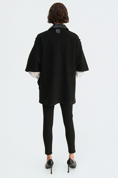 Cape with a combination of leather-look and wool fabric