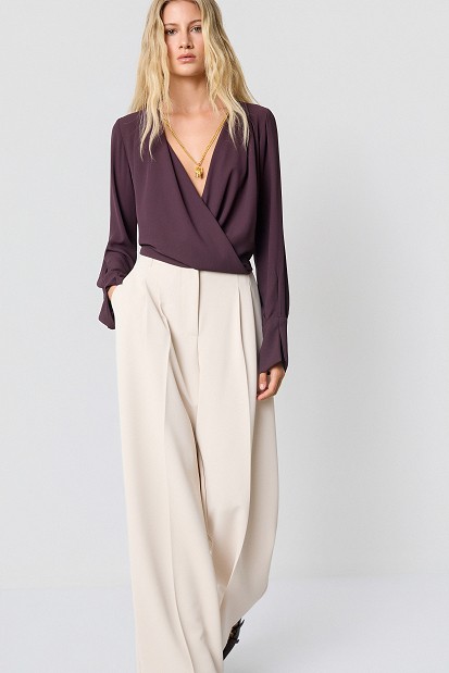 Wrap blouse with a decorative necklace