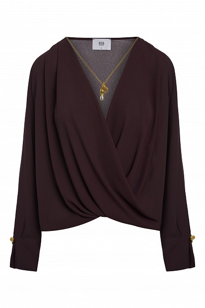 Wrap blouse with a decorative necklace