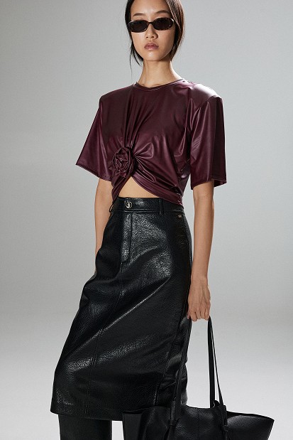 Cropped faux leather blouse with decorative flower