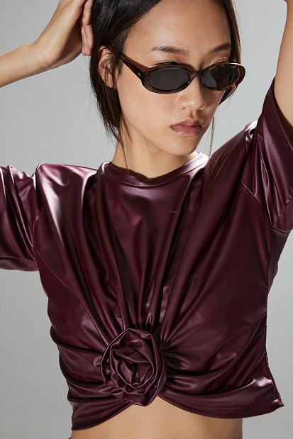 Cropped faux leather blouse with decorative flower