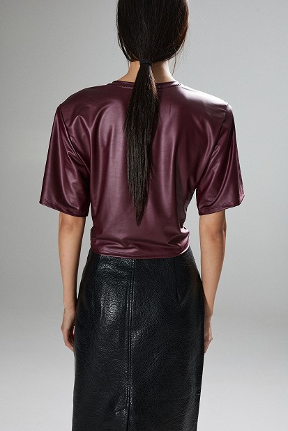 Cropped faux leather blouse with decorative flower