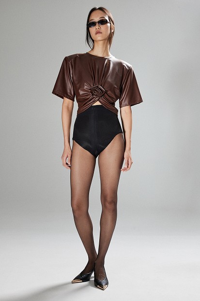 Cropped faux leather blouse with decorative flower