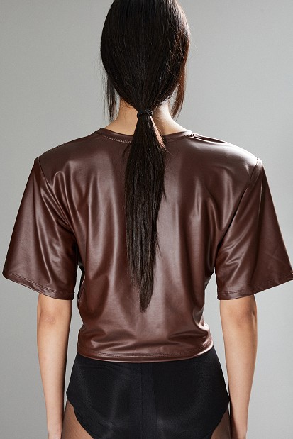 Cropped faux leather blouse with decorative flower