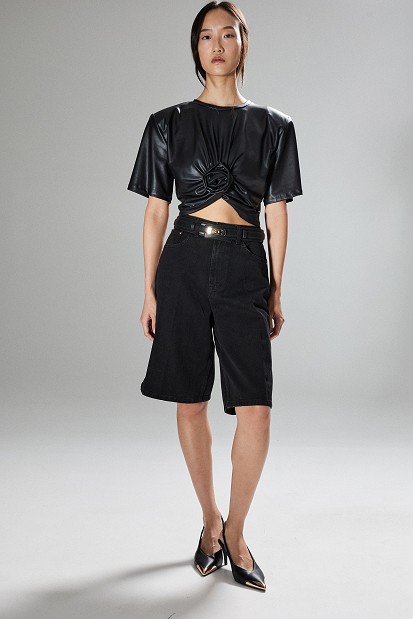 Cropped faux leather blouse with decorative flower
