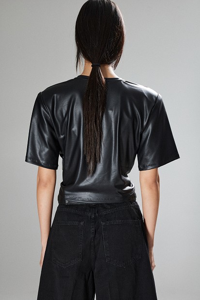 Cropped faux leather blouse with decorative flower