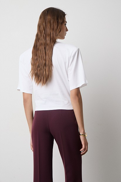 Cropped top with shoulder pads and appliqué flower