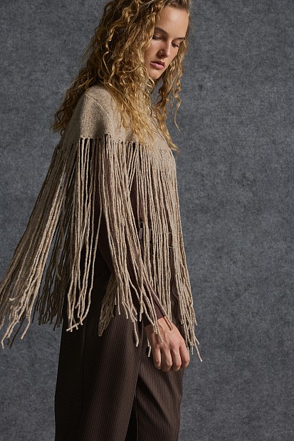 Knitted fringed cape