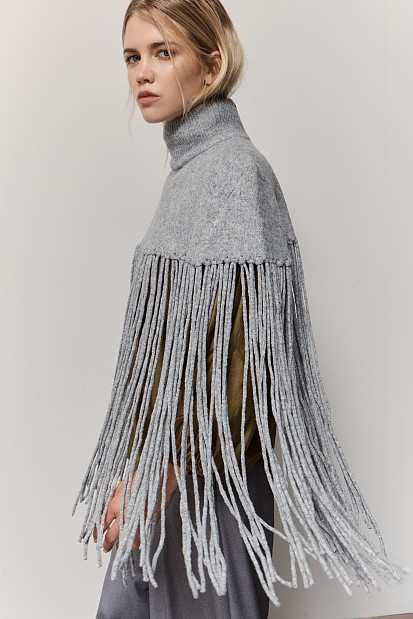 Knitted fringed cape