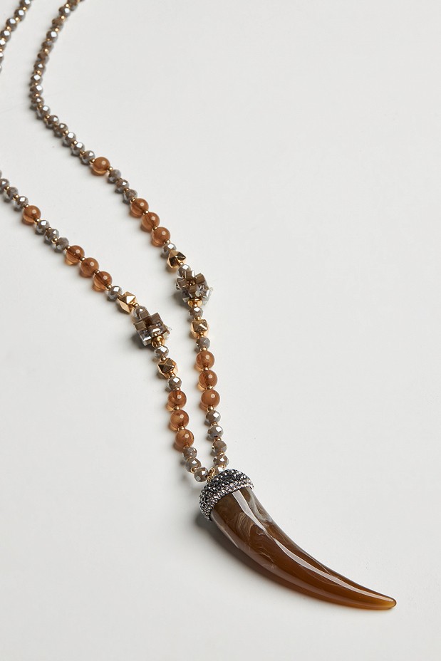 Long necklace with decorative tooth