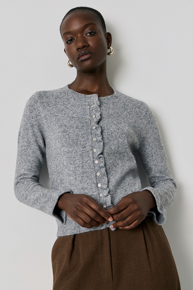 Knitted cardigan with jewel buttons and ruffles
