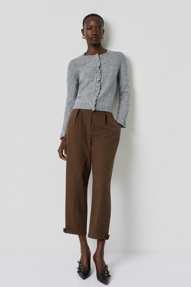 Knitted cardigan with jewel buttons and ruffles