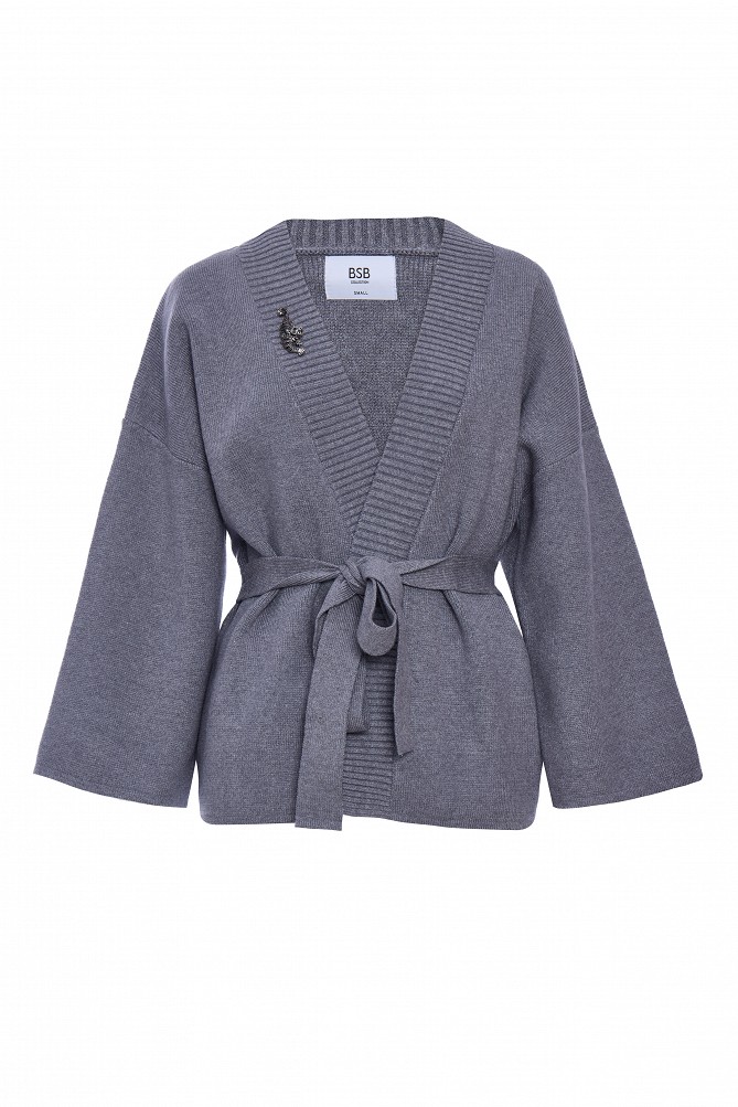 Cardigan with a belt and brooch.