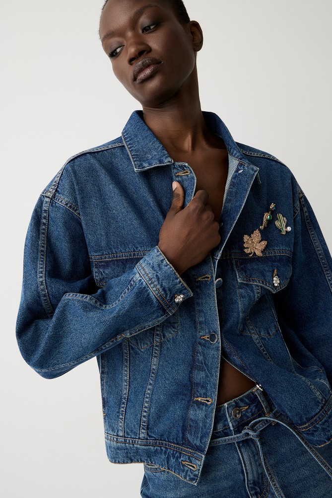 Denim jacket with decorative pins