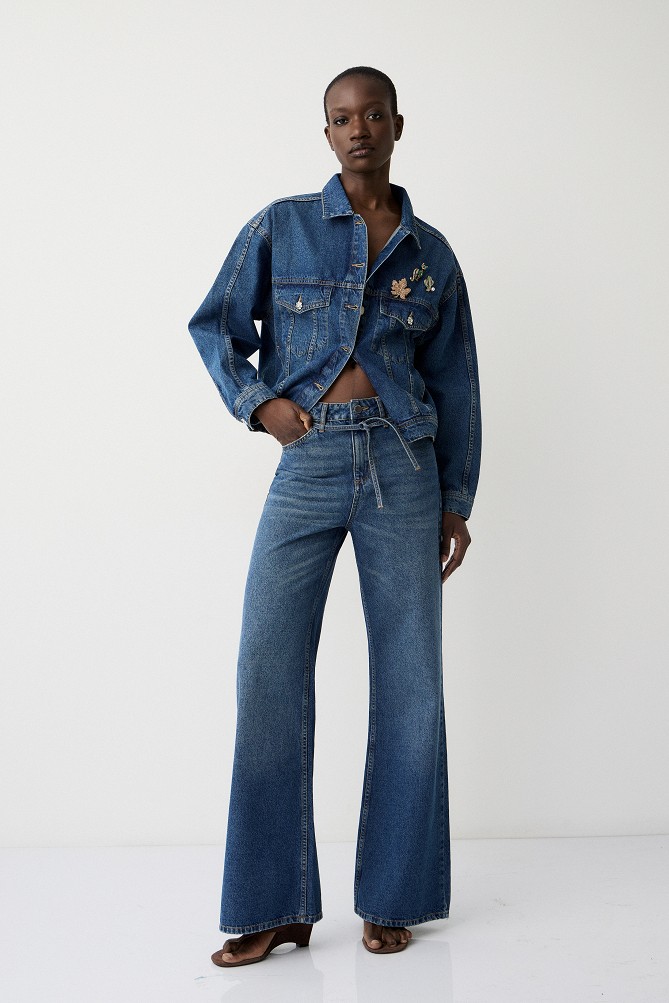 Denim jacket with decorative pins