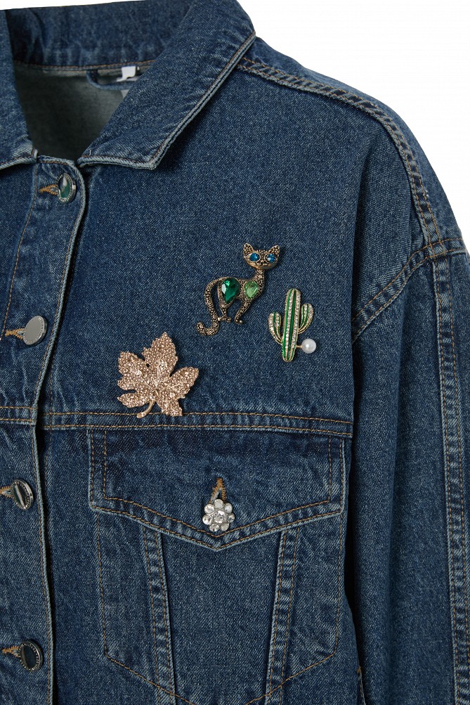 Denim jacket with decorative pins