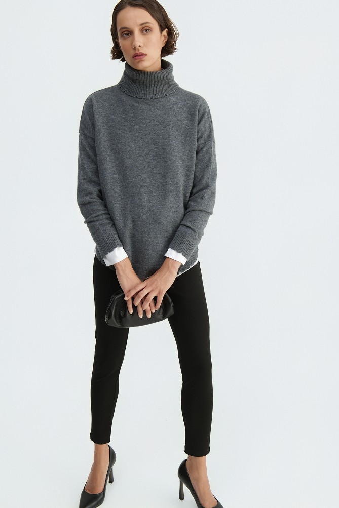 Wool turtleneck sweater with distressed details