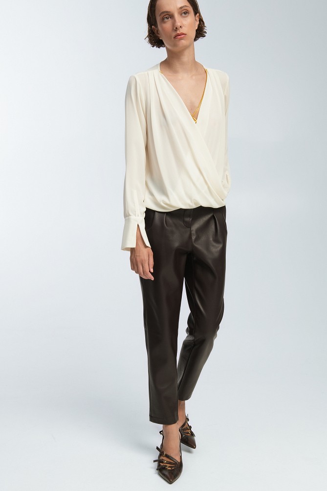 Wrap blouse with a decorative necklace
