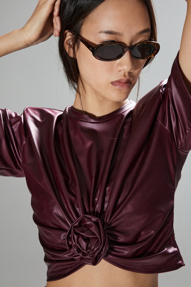 Cropped faux leather blouse with decorative flower