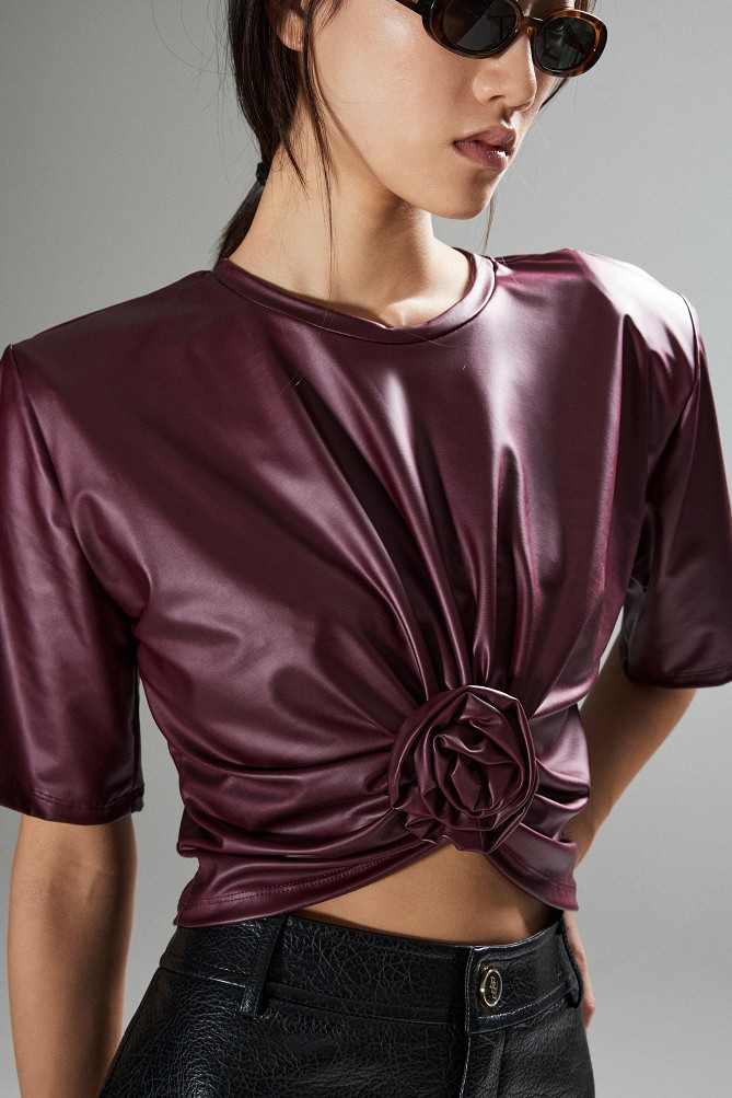 Cropped faux leather blouse with decorative flower