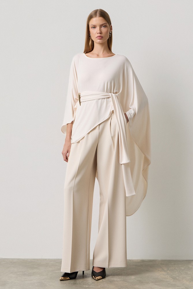Poncho with a decorative buckle