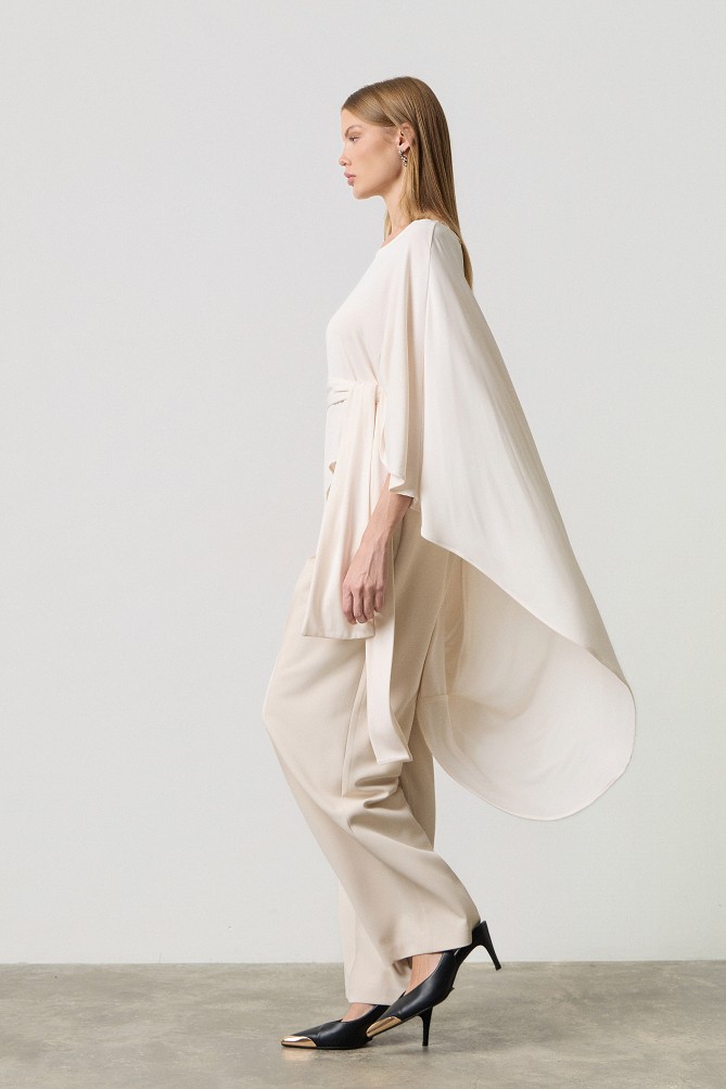 Poncho with a decorative buckle
