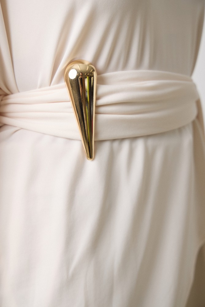 Poncho with a decorative buckle