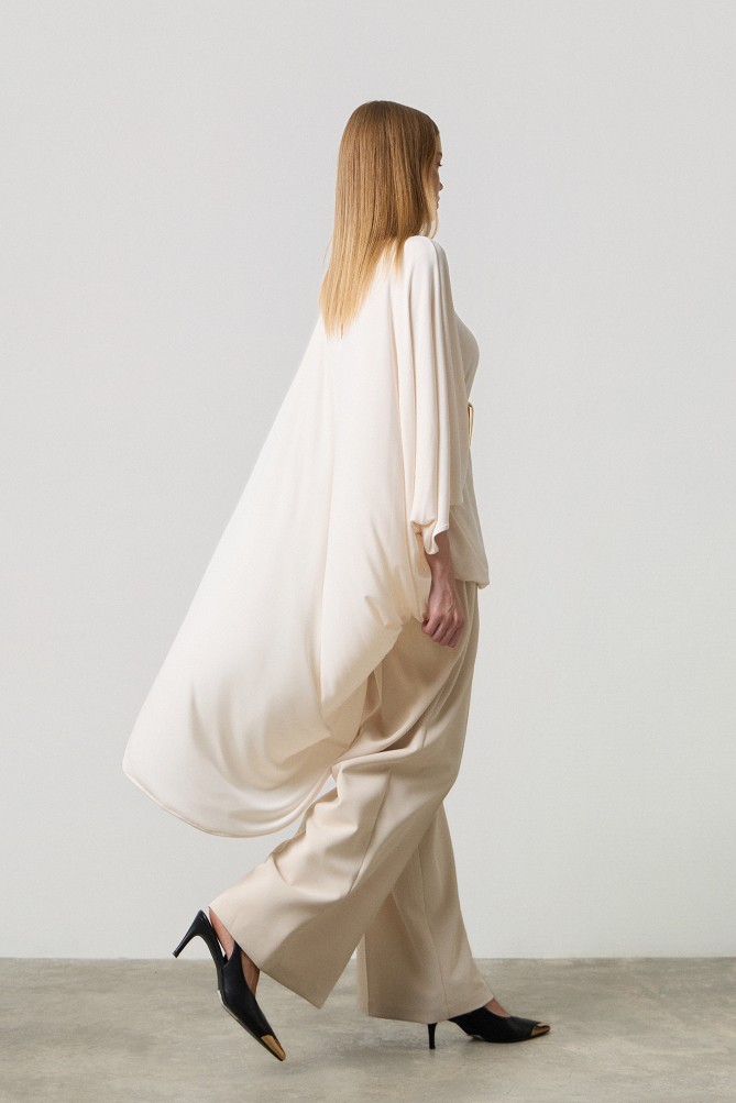 Poncho with a decorative buckle