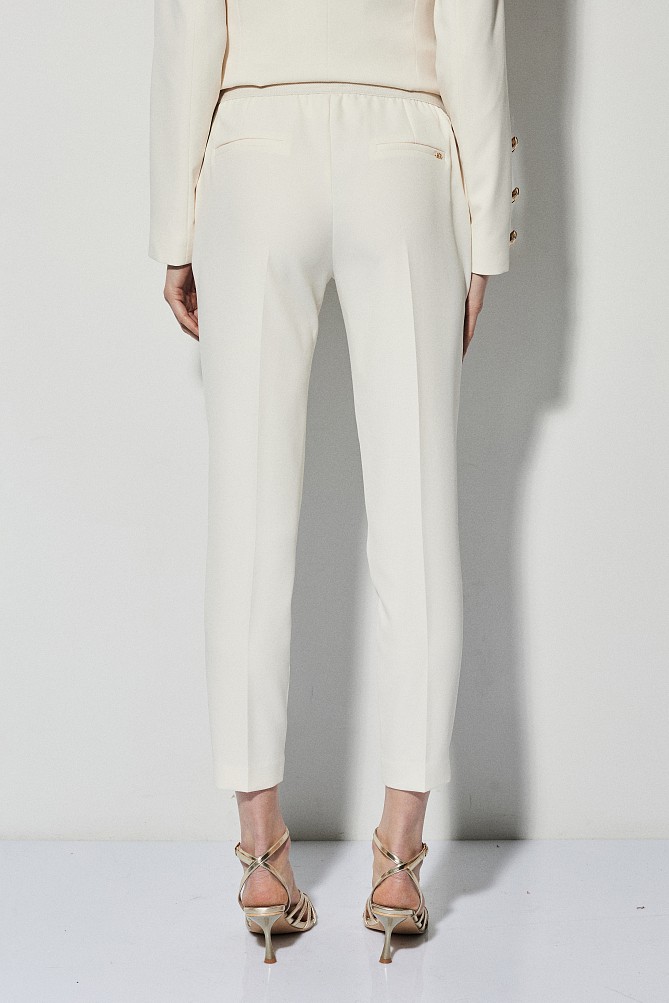 Trousers with bejeweled buttons