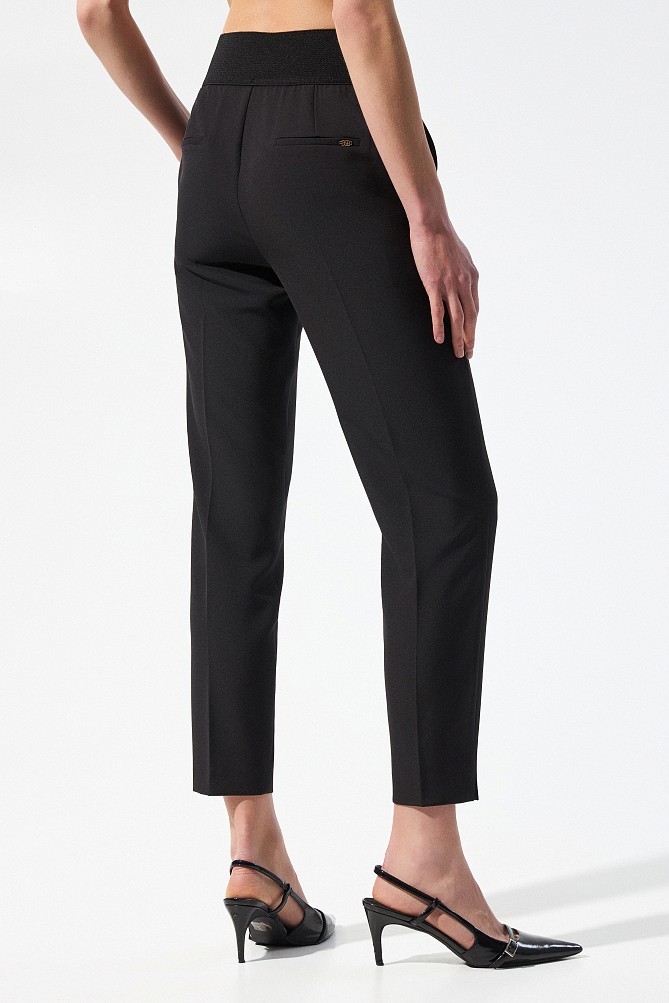 Trousers with bejeweled buttons