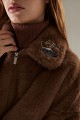 Cropped bomber jacket with decorative pins on the collar