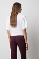 Cropped top with shoulder pads and appliqué flower